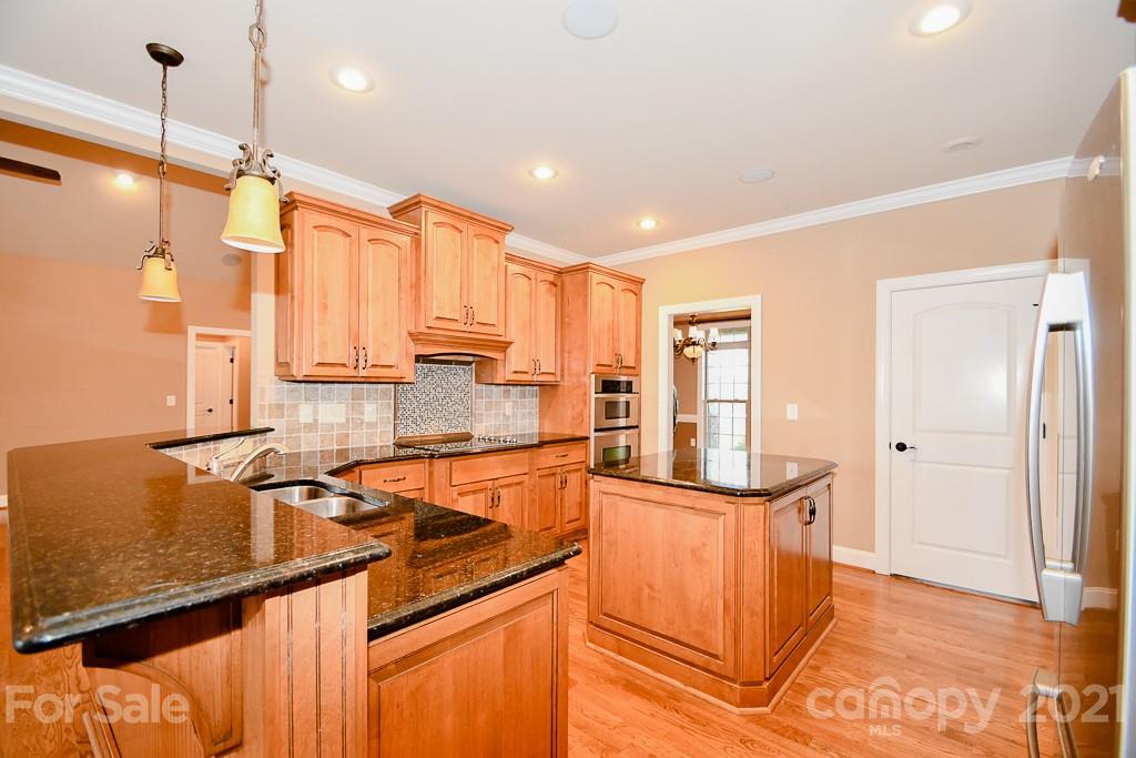 721 Roy Kindley Road Monroe, NC 28110 - Photo 14 of 32 a kitchen with stainless steel appliances granite countertop a sink a stove and a refrigerator
