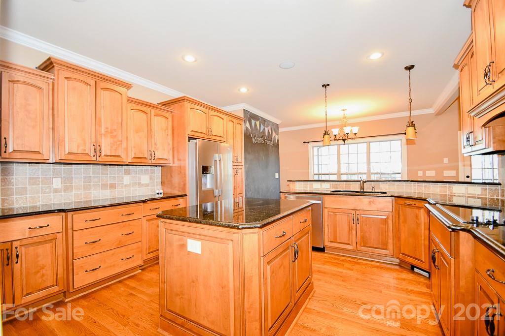721 Roy Kindley Road Monroe, NC 28110 - Photo 15 of 32 a large kitchen with stainless steel appliances granite countertop a sink and cabinets