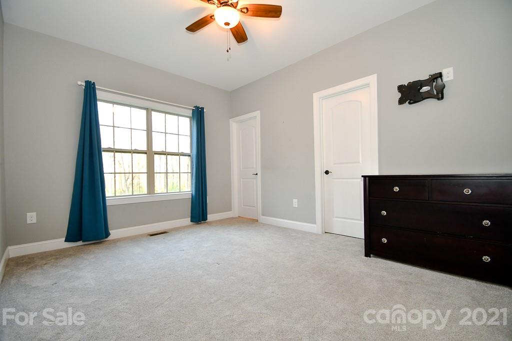 721 Roy Kindley Road Monroe, NC 28110 - Photo 18 of 32 an empty room with windows and cabinet