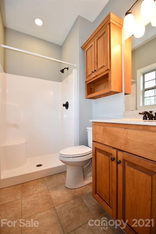 721 Roy Kindley Road Monroe, NC 28110 - Photo 19 of 32 a bathroom with a sink a toilet and shower