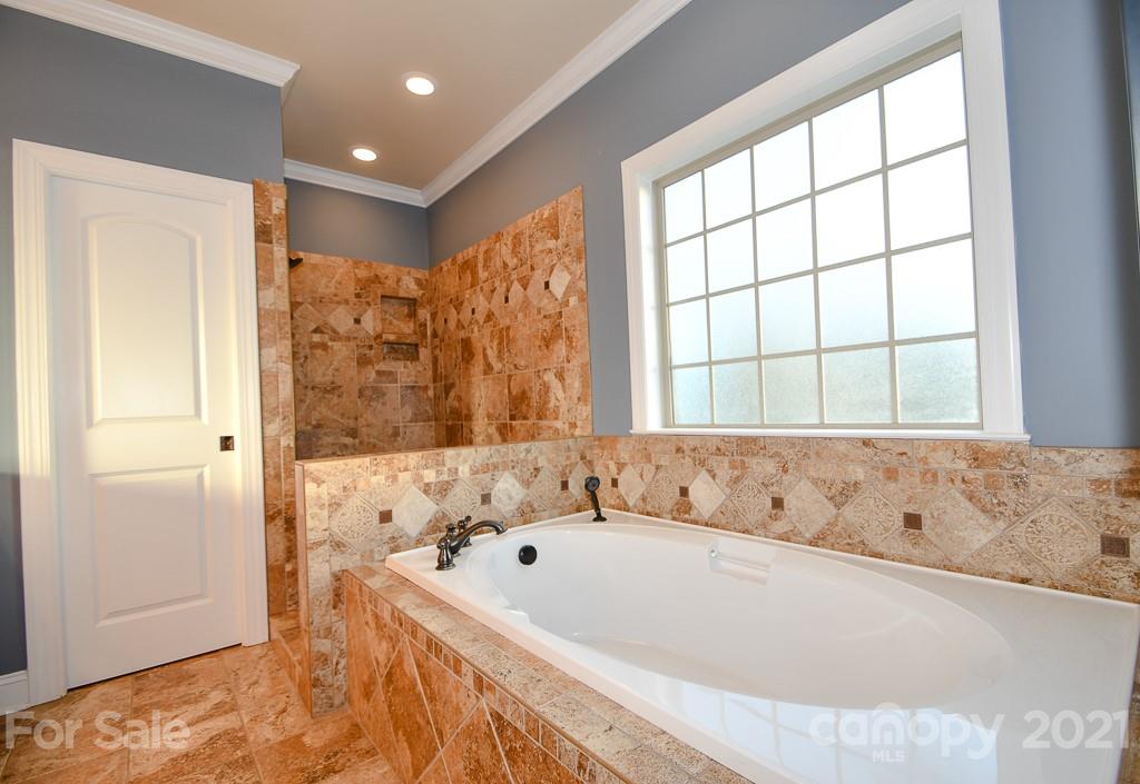 721 Roy Kindley Road Monroe, NC 28110 - Photo 22 of 32 a bathroom with a bathtub and shower
