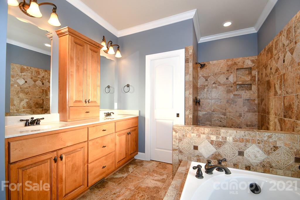 721 Roy Kindley Road Monroe, NC 28110 - Photo 23 of 32 a bathroom with a tub sink and mirror