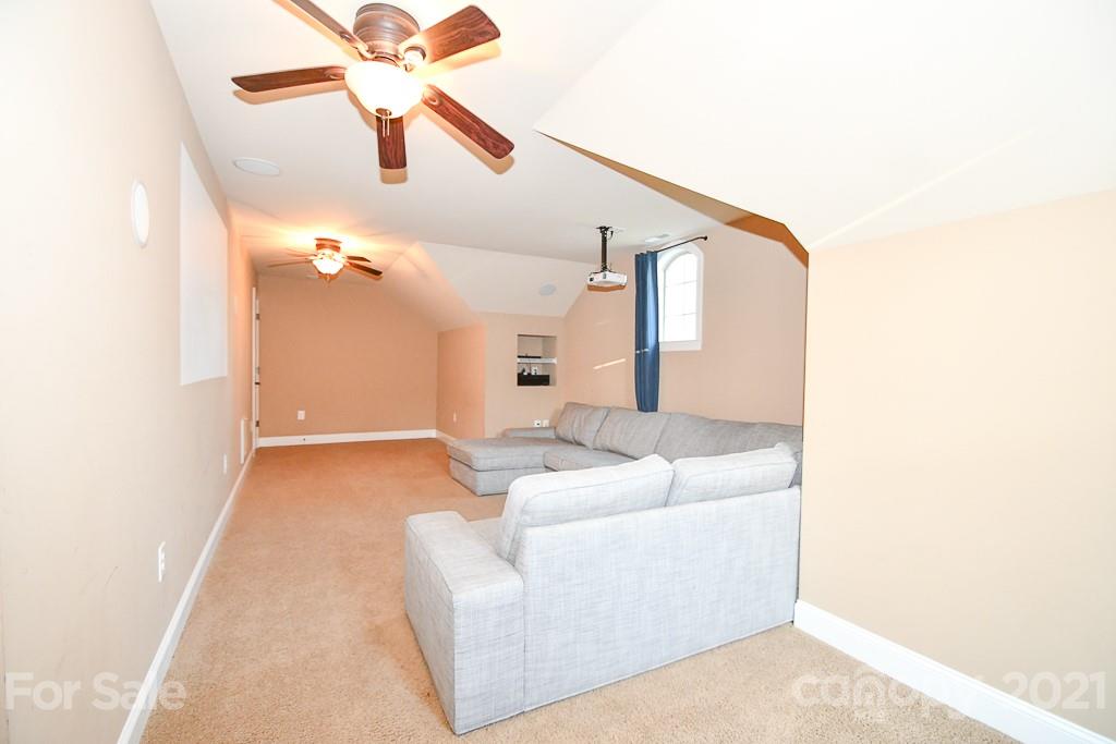 721 Roy Kindley Road Monroe, NC 28110 - Photo 30 of 32 a living room with furniture and a chandelier