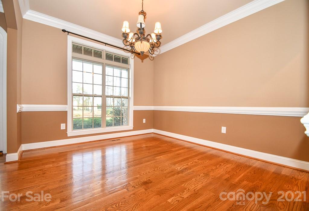 721 Roy Kindley Road Monroe, NC 28110 - Photo 9 of 32 a view of an empty room with wooden floor and a window
