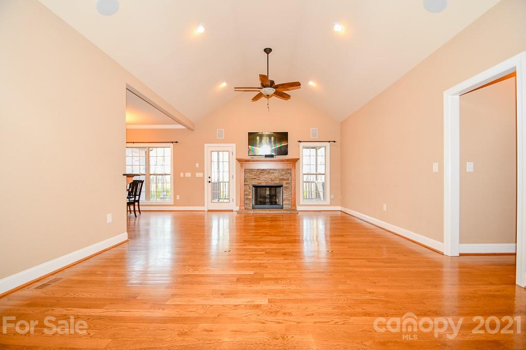 721 Roy Kindley Road Monroe, NC 28110 - Photo 10 of 32 a view of a livingroom with a fireplace a ceiling fan and wooden floor