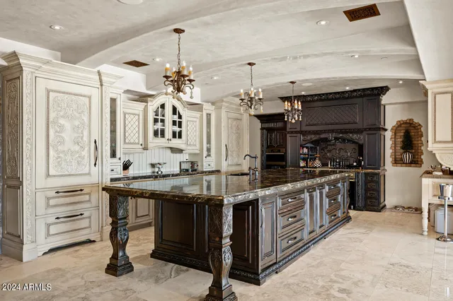 a kitchen with stainless steel appliances granite countertop a sink and a refrigerator