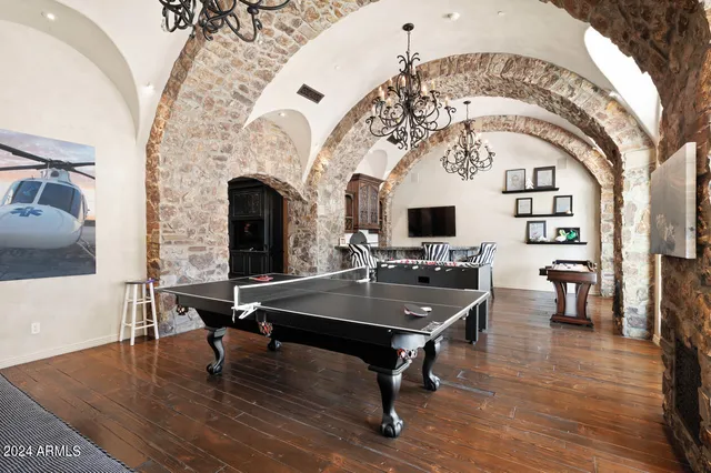 a front view of a house with balcony and outdoor seating