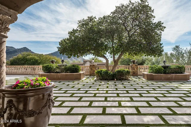 a roof deck with a couches and sky view