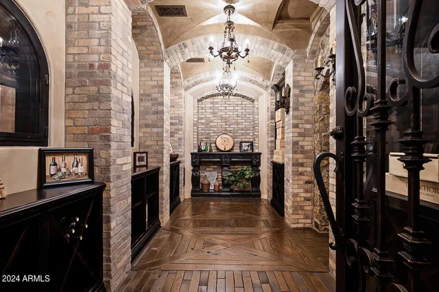 a bedroom with a large bed and a chandelier