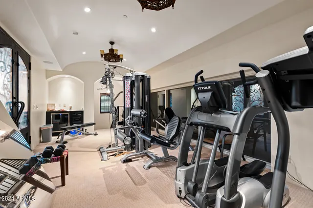 a view of a patio with table and chairs potted plants with floor to ceiling window