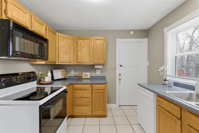 a kitchen with granite countertop cabinets stainless steel appliances and a sink