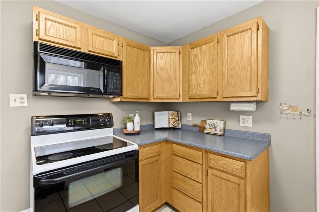 2609 Lah Road Gibsonia, PA 15044 - Photo 19 of 48 a kitchen with stainless steel appliances granite countertop a stove microwave and cabinets