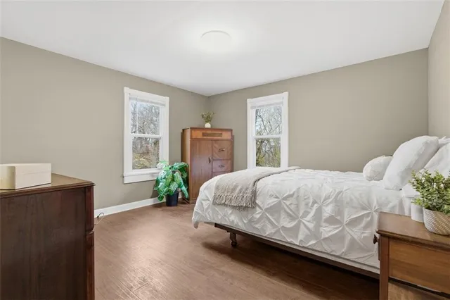 a bedroom with a bed potted plant and a window