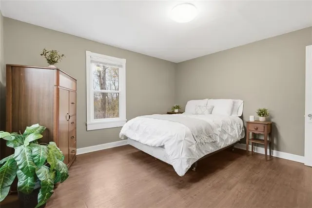 a bedroom with a bed and a large mirror on dresser