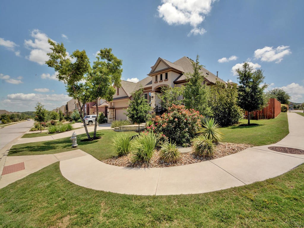 5525 Cherokee Draw Road Austin, TX 78738 - Photo 1 of 1 a view of a garden with a fountain