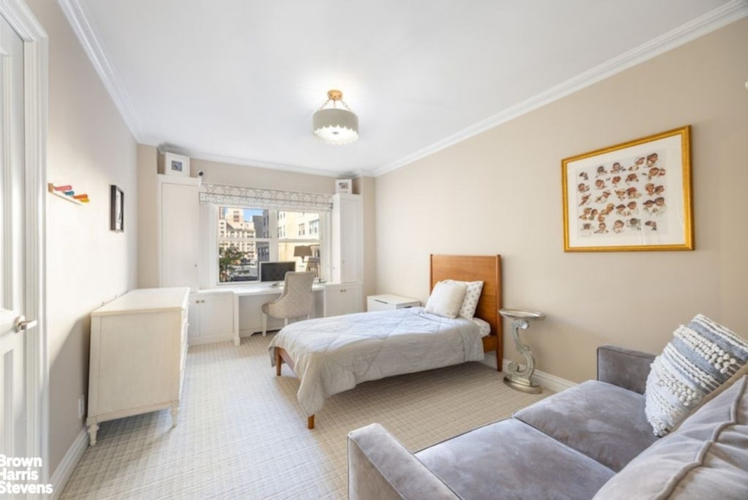 370 East 76th Street, Unit A1002 Manhattan, NY 10021 - Photo 9 of 13 a bedroom with a bed and a couch