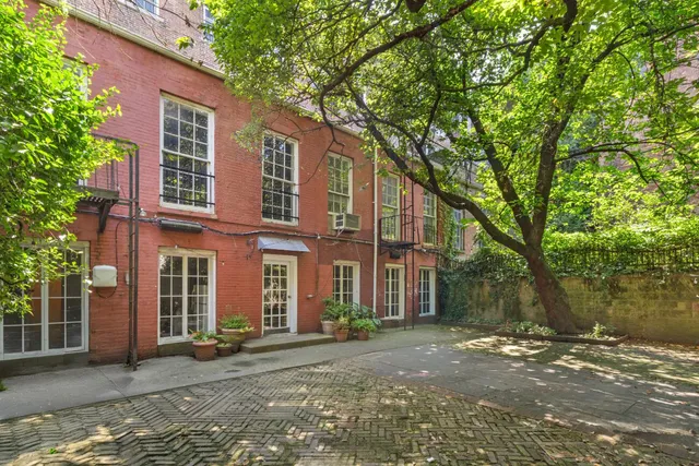 a backyard of a house with table and chairs
