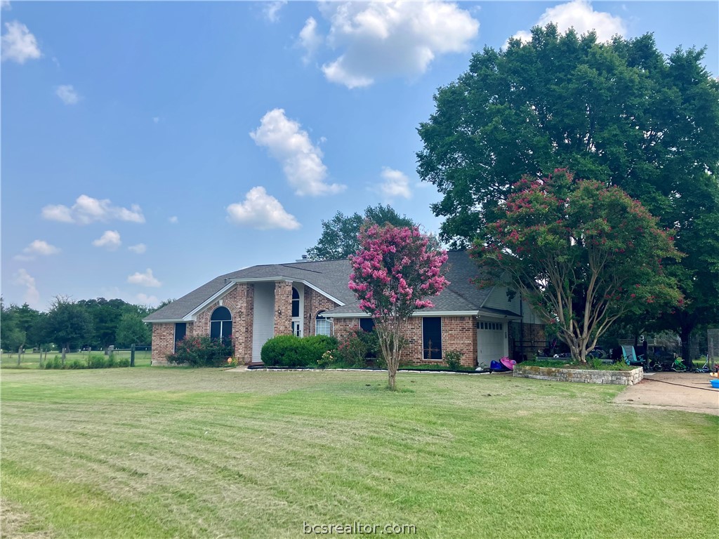 5660 Falling Water Bryan, TX 77808 - Photo 2 of 27 Ranch-style home with a front yard