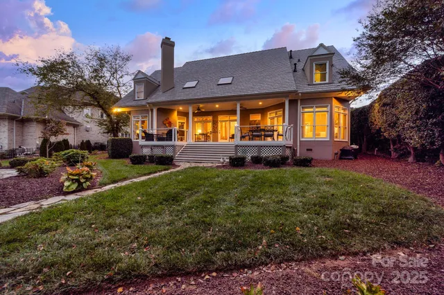 a front view of a house with a garden and plants