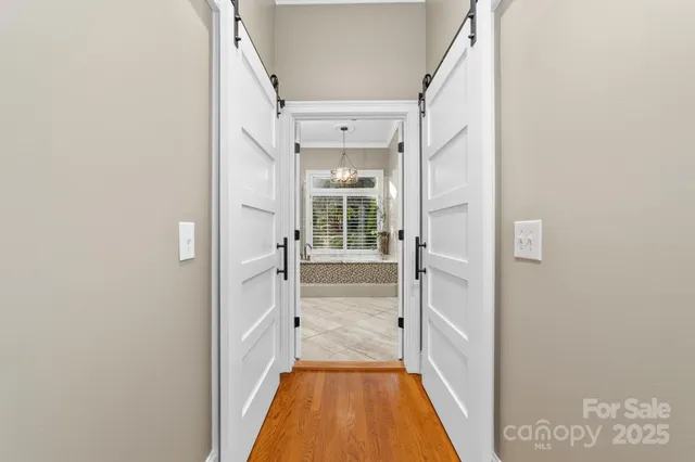 a spacious bathroom with a granite countertop sink a large mirror and a bathtub