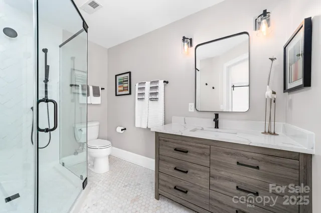 a bedroom with a bed and a night stand