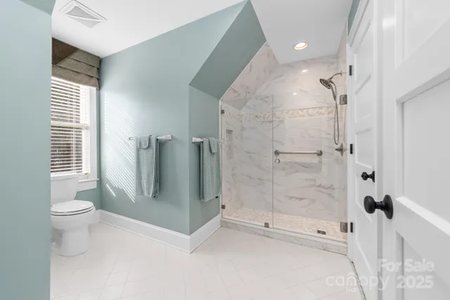 a bathroom with a granite countertop sink a mirror and a shower