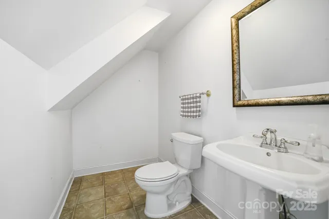 front view of a brick house with a small yard