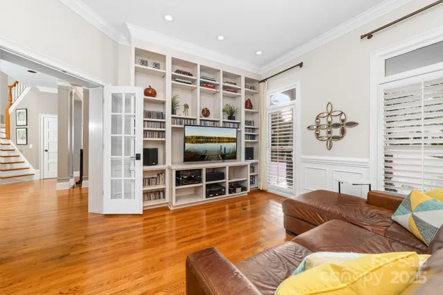 a living room with furniture windows and wooden floor