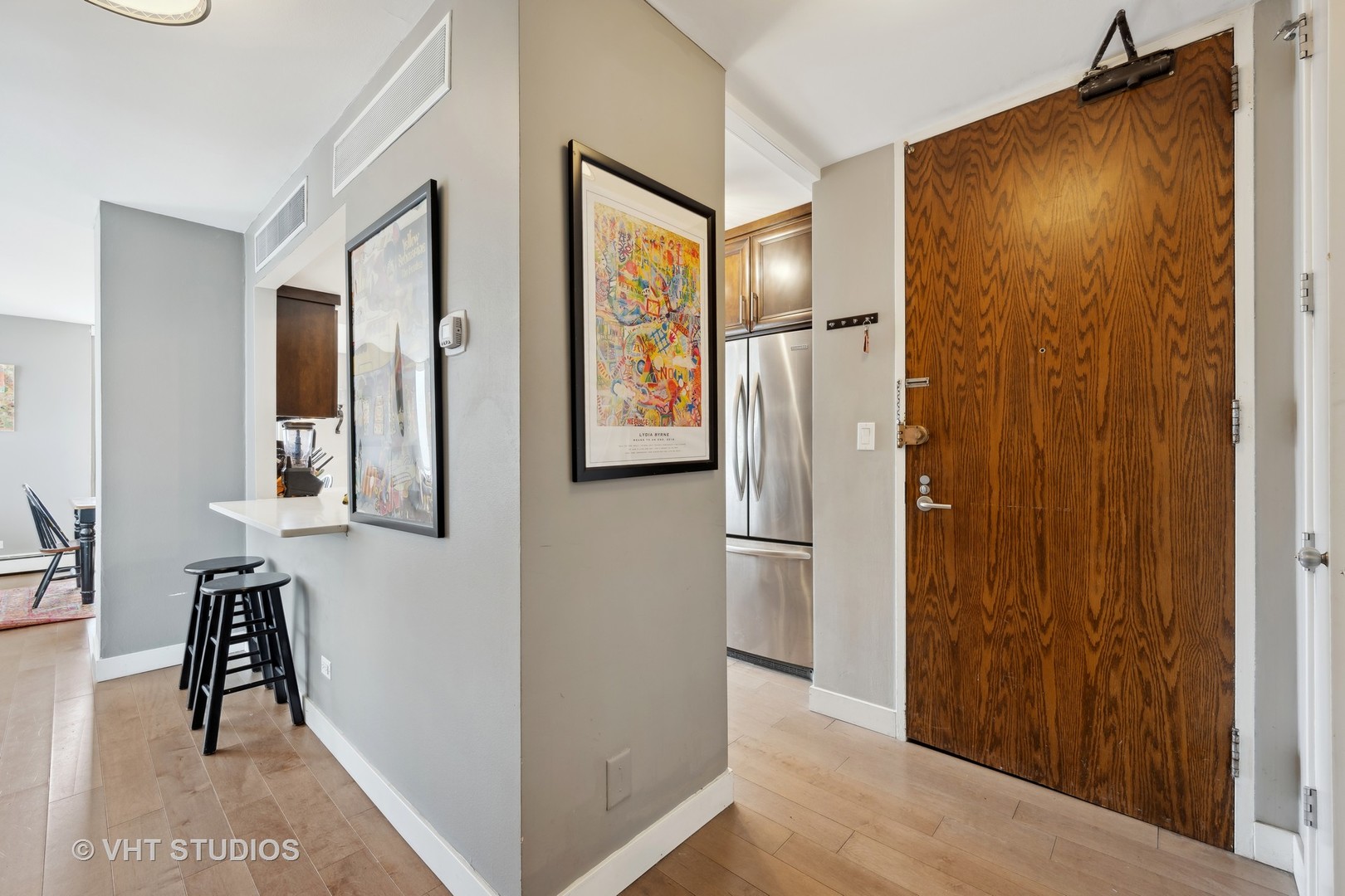 1310 North Ritchie Court, Unit 19C Chicago, IL 60610 - Photo 2 of 10 a view of hallway with furniture and a refrigerator