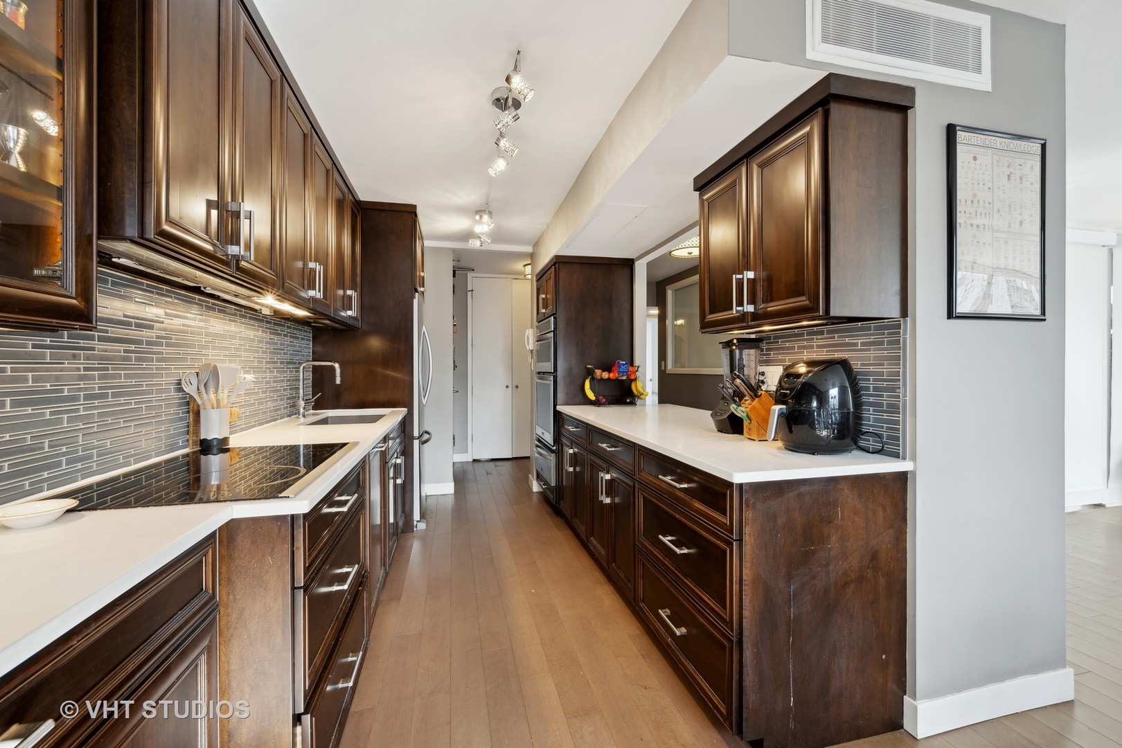 1310 North Ritchie Court, Unit 19C Chicago, IL 60610 - Photo 6 of 10 a kitchen with stainless steel appliances granite countertop a sink a stove and a refrigerator
