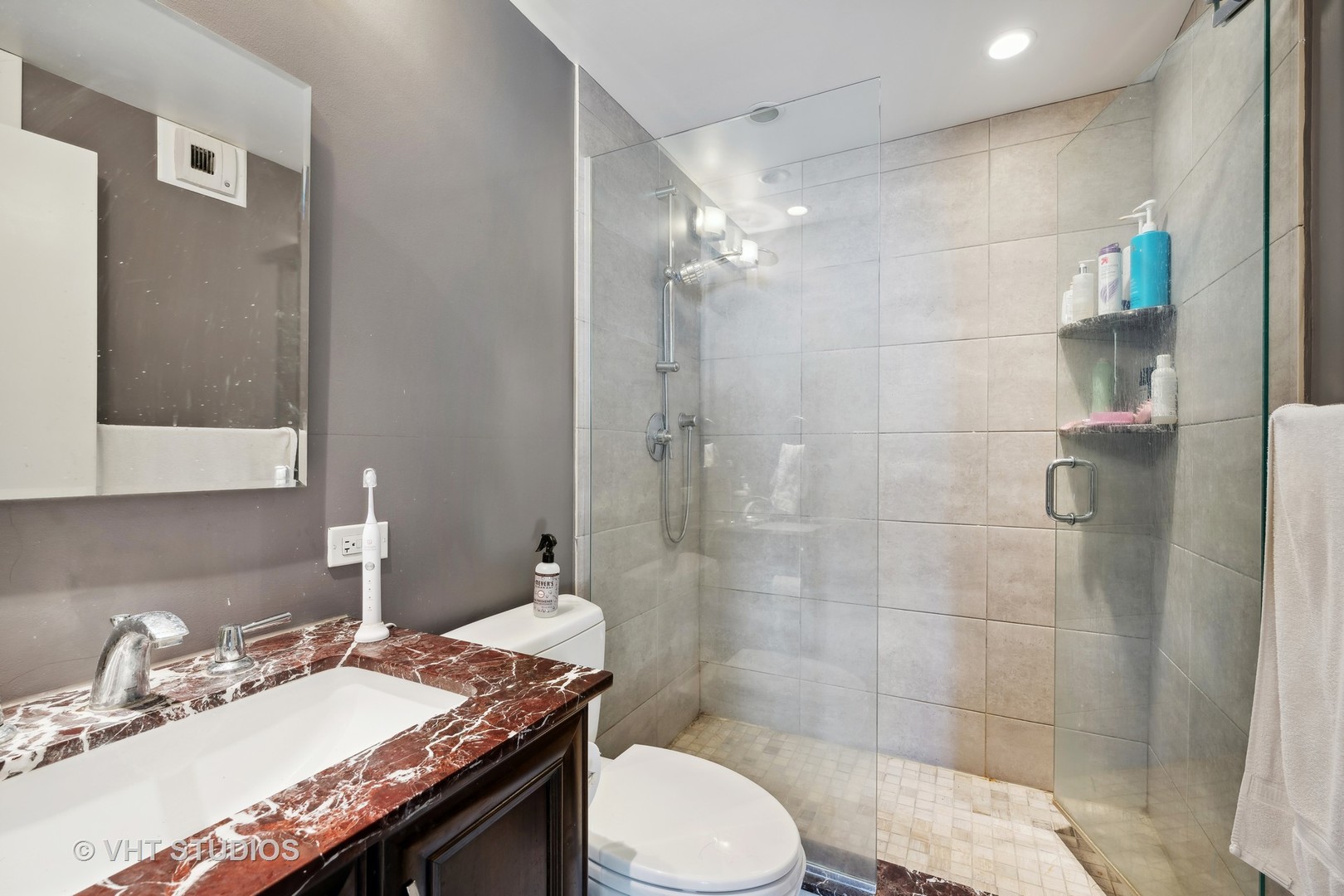 1310 North Ritchie Court, Unit 19C Chicago, IL 60610 - Photo 9 of 10 a bathroom with a granite countertop sink toilet a mirror and shower