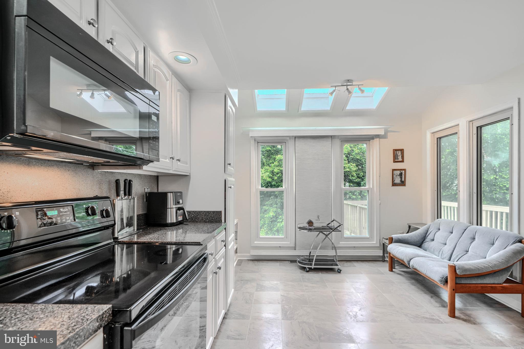 1 Second Tee Court Baltimore, MD 21209 - Photo 13 of 41 a living room with furniture and floor to ceiling windows