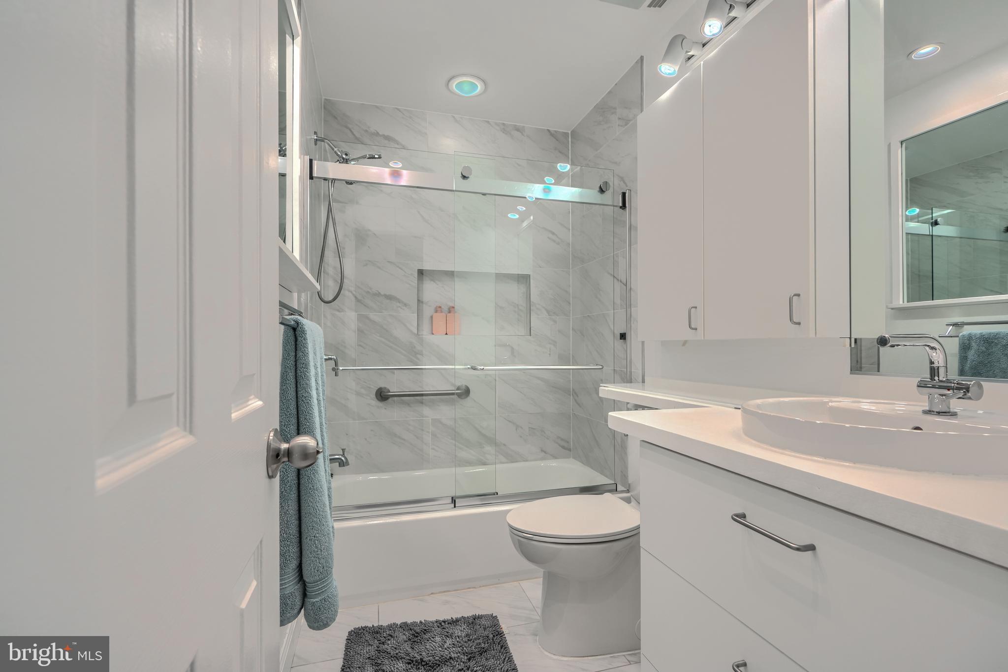 1 Second Tee Court Baltimore, MD 21209 - Photo 27 of 41 a bathroom with a granite countertop sink toilet and shower