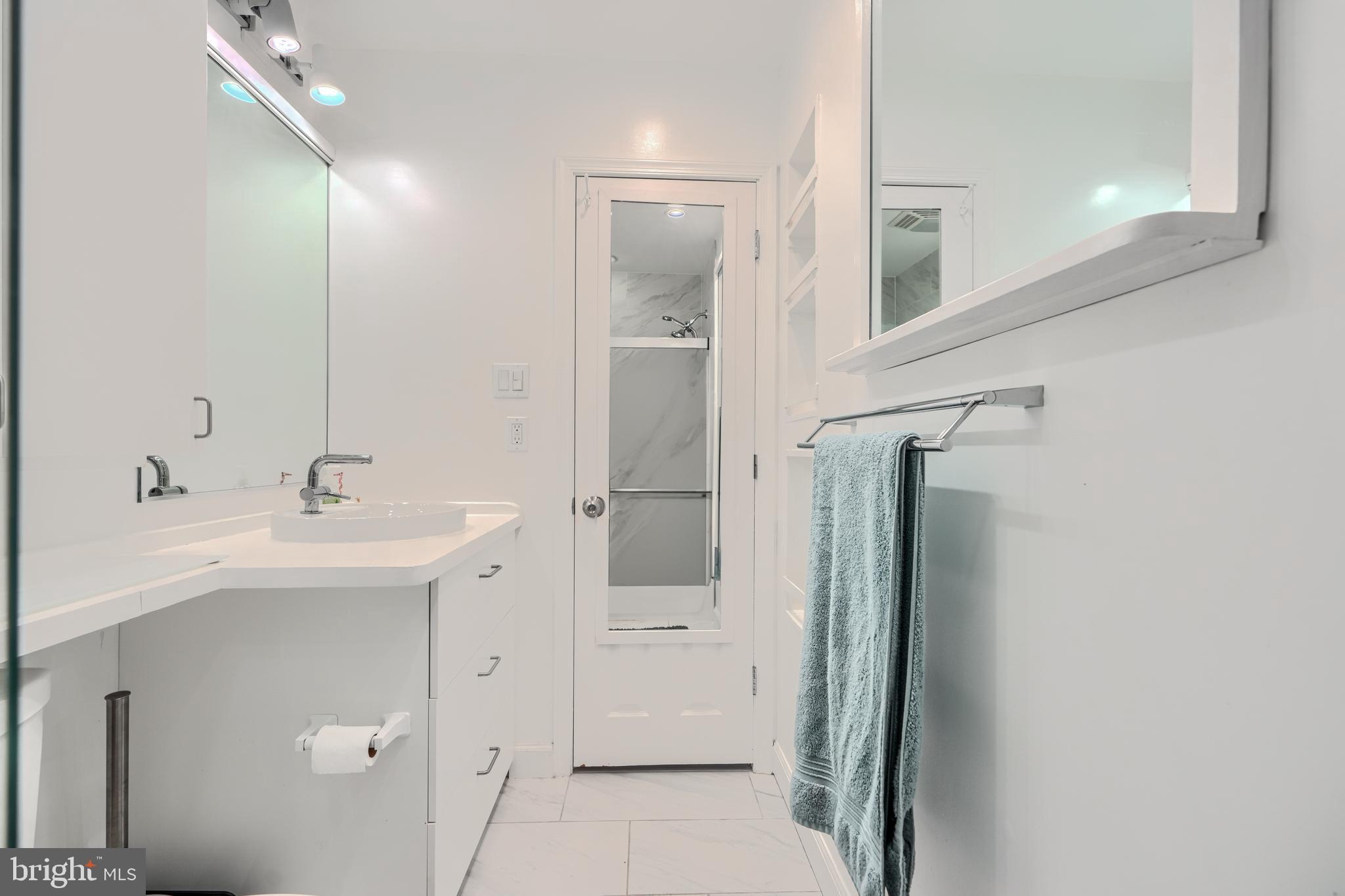 1 Second Tee Court Baltimore, MD 21209 - Photo 29 of 41 a bathroom with a sink a mirror and shower