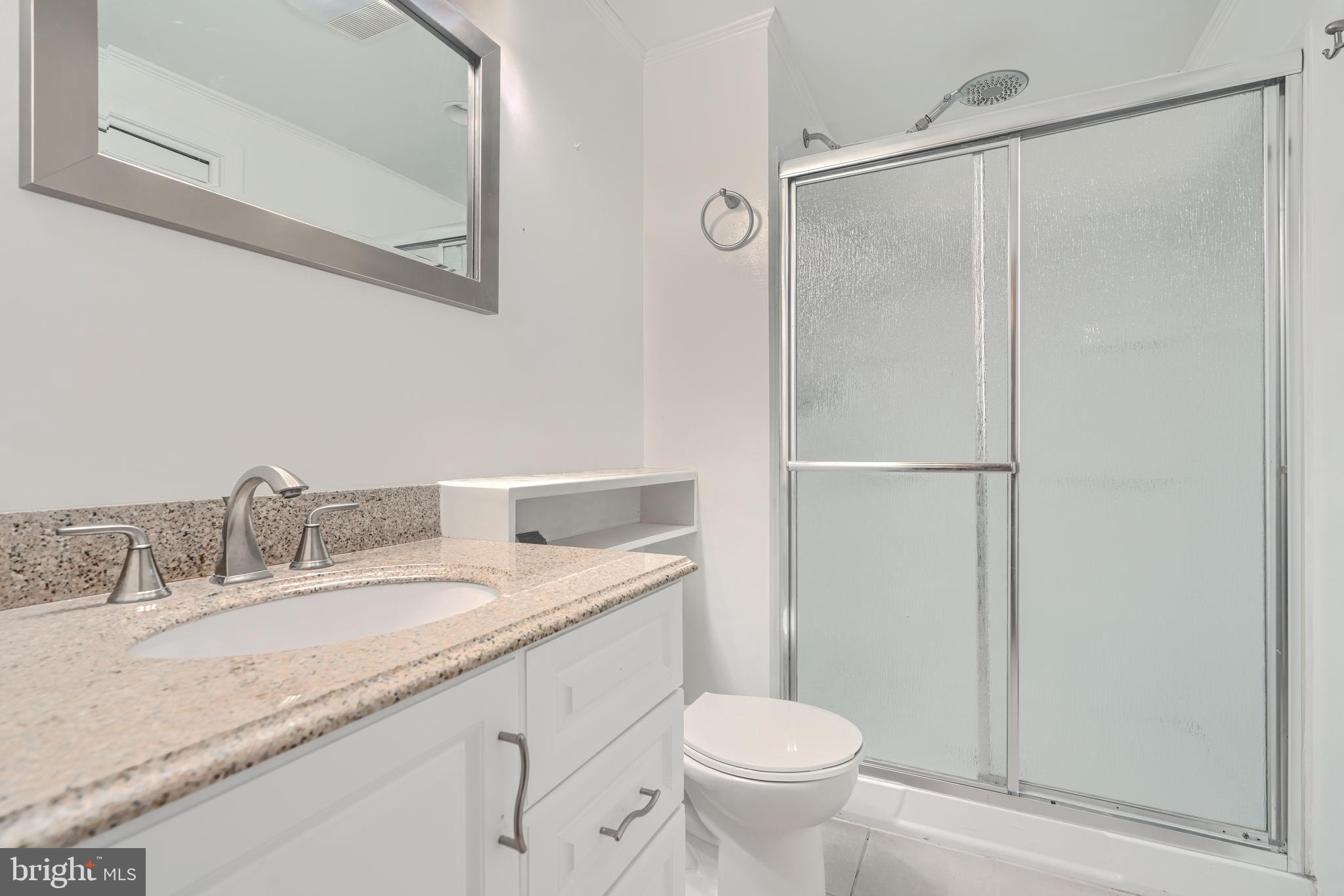 1 Second Tee Court Baltimore, MD 21209 - Photo 37 of 41 a bathroom with a granite countertop sink toilet and shower