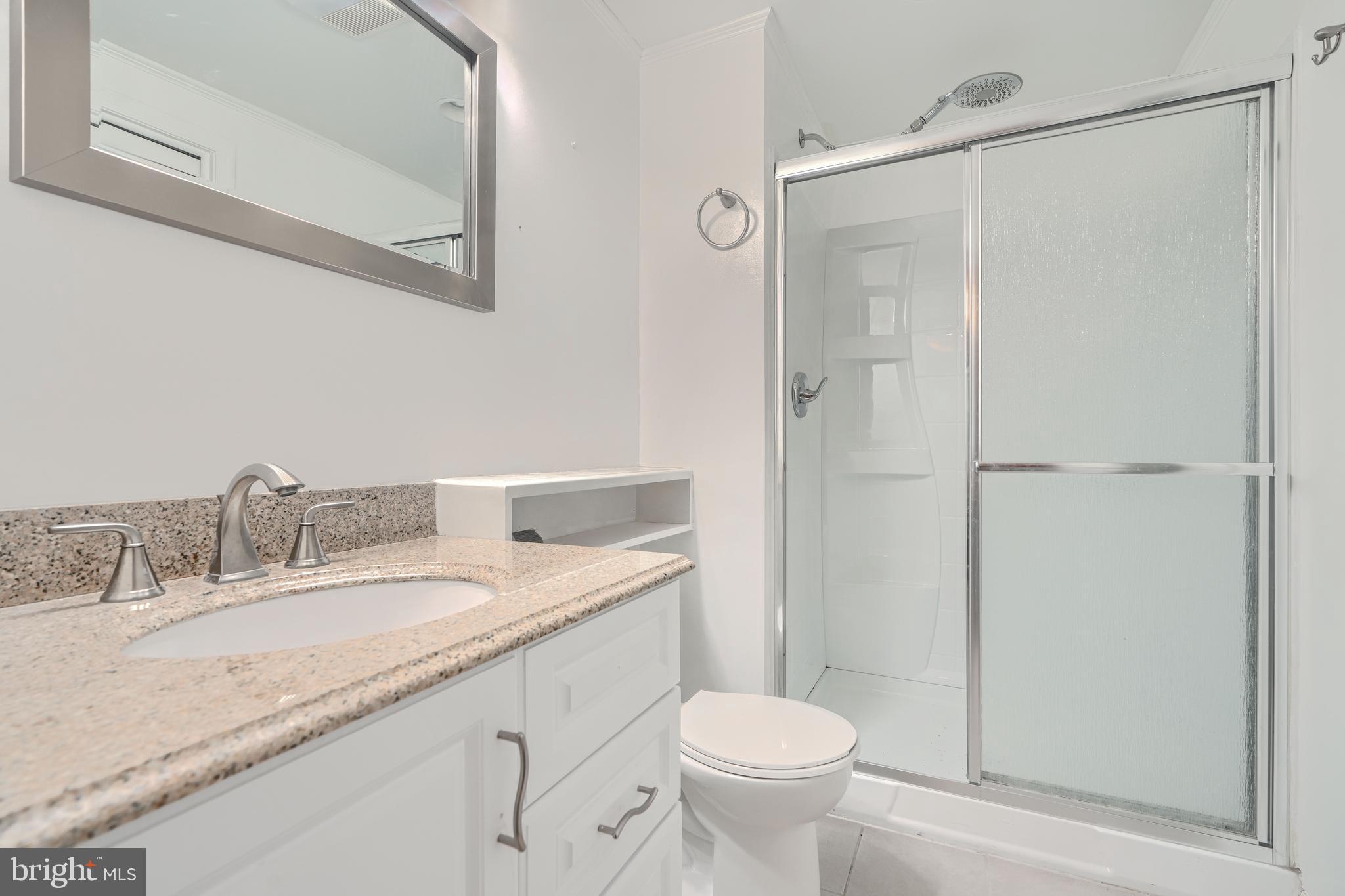 1 Second Tee Court Baltimore, MD 21209 - Photo 38 of 41 a bathroom with a granite countertop sink toilet and shower