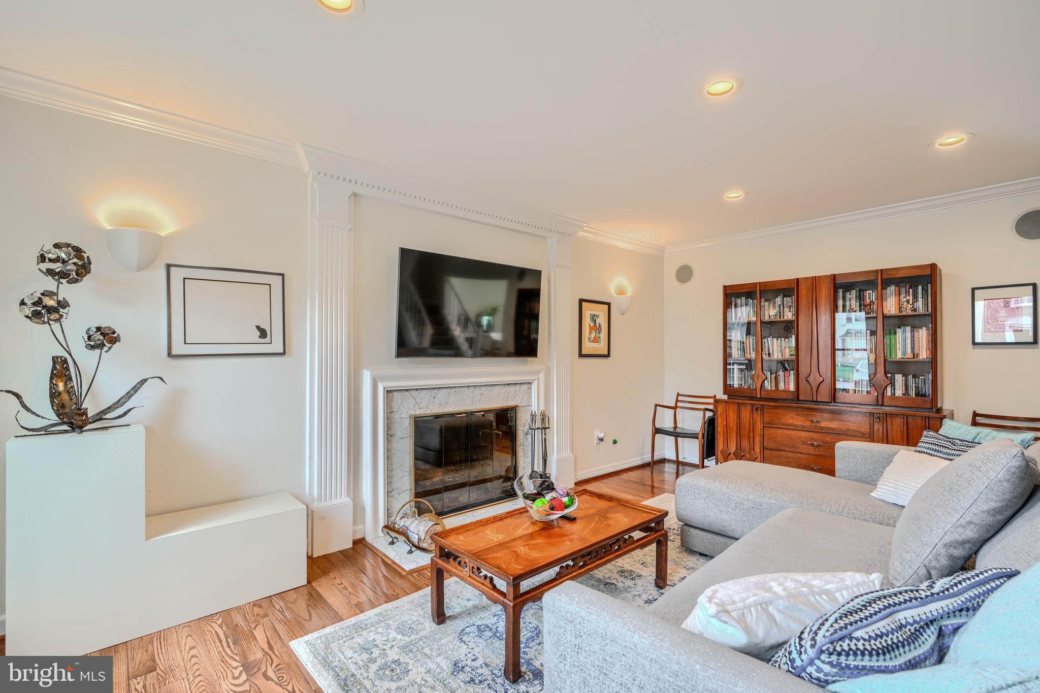 1 Second Tee Court Baltimore, MD 21209 - Photo 4 of 41 a living room with furniture a flat screen tv and a fireplace