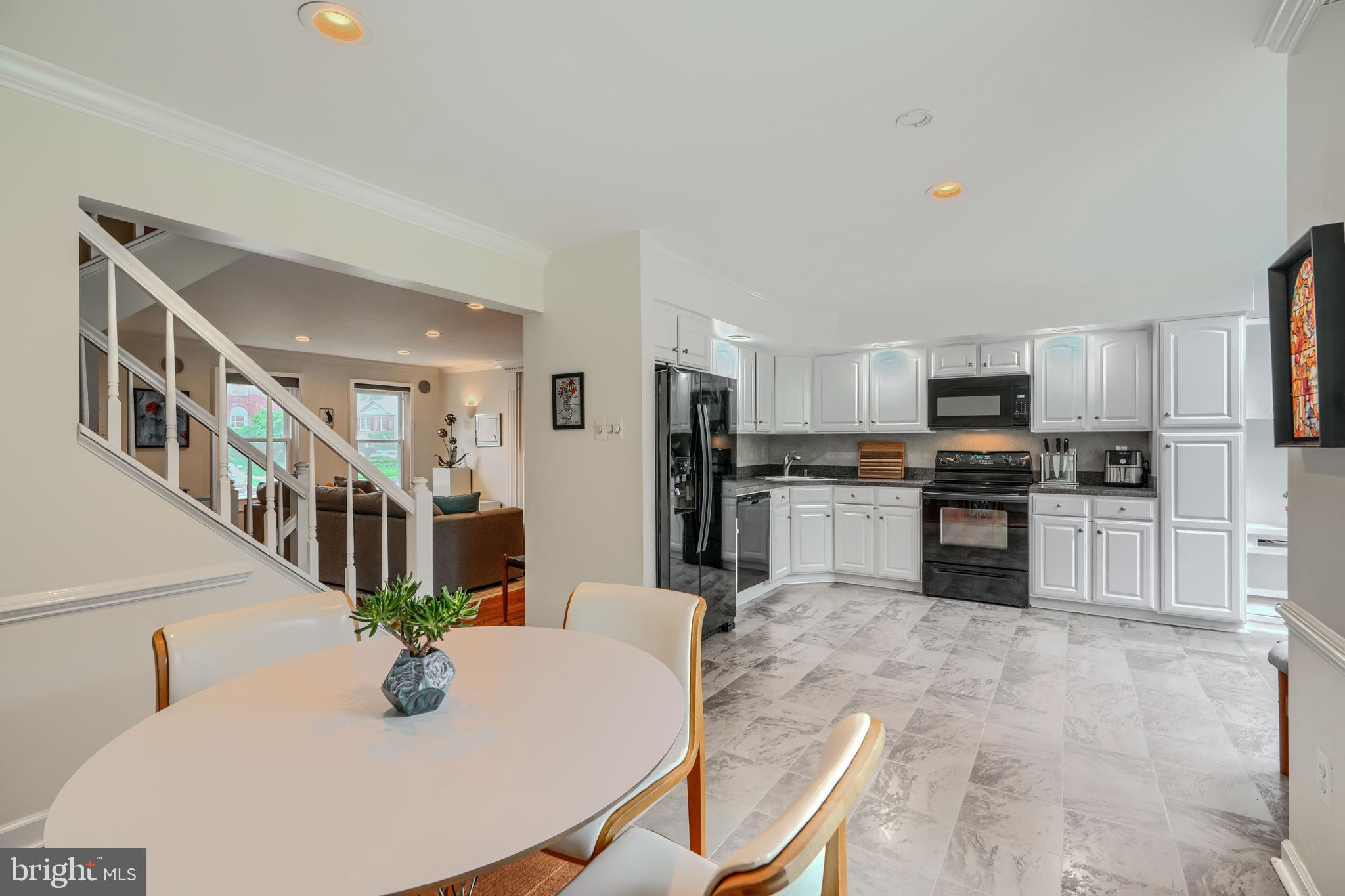 1 Second Tee Court Baltimore, MD 21209 - Photo 9 of 41 a kitchen with granite countertop a refrigerator a stove a sink a dining table and chairs