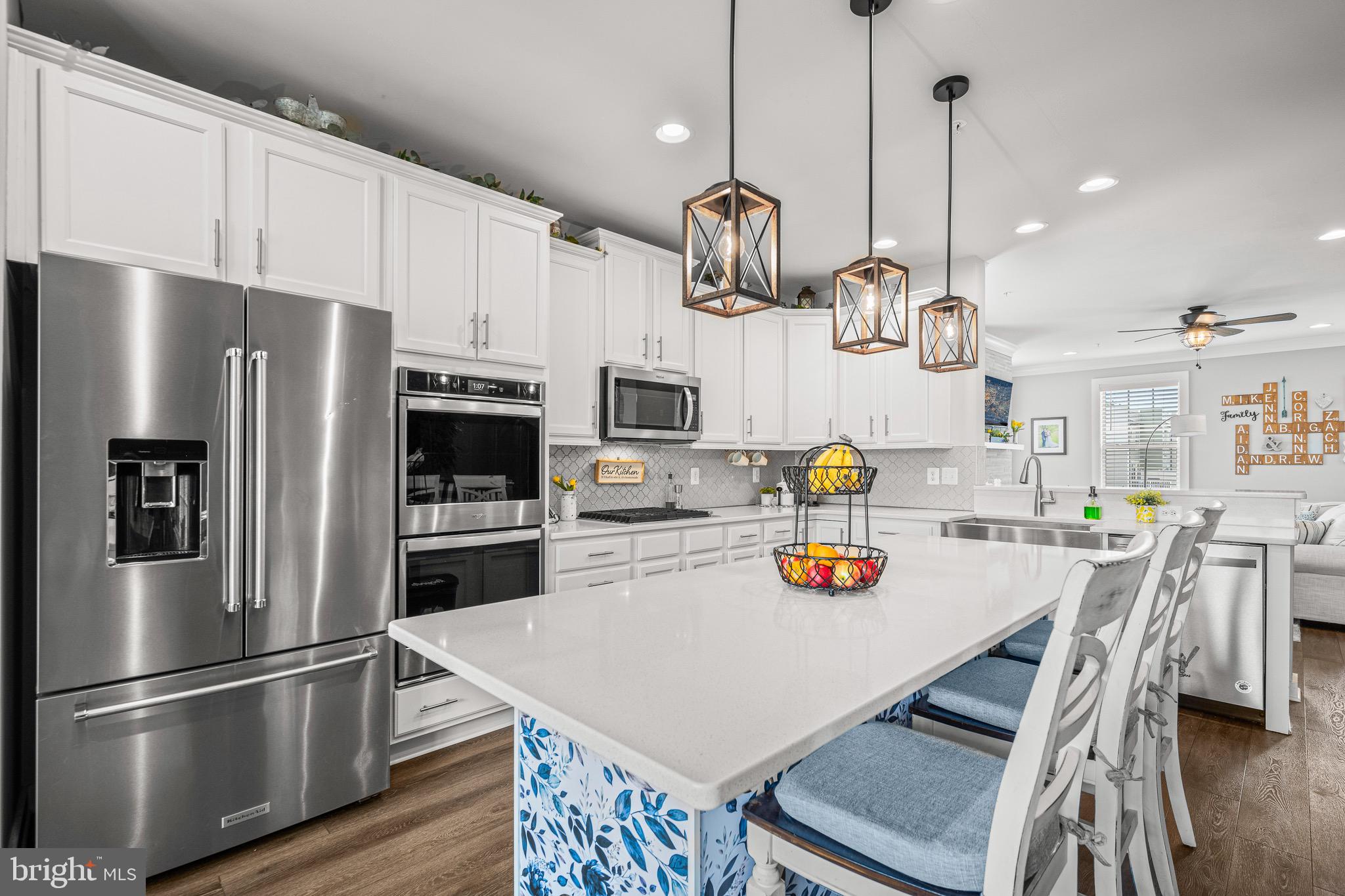 3451 Flatwoods Drive Frederick, MD 21704 - Photo 14 of 43 a kitchen with stainless steel appliances a refrigerator a sink a stove and white cabinets