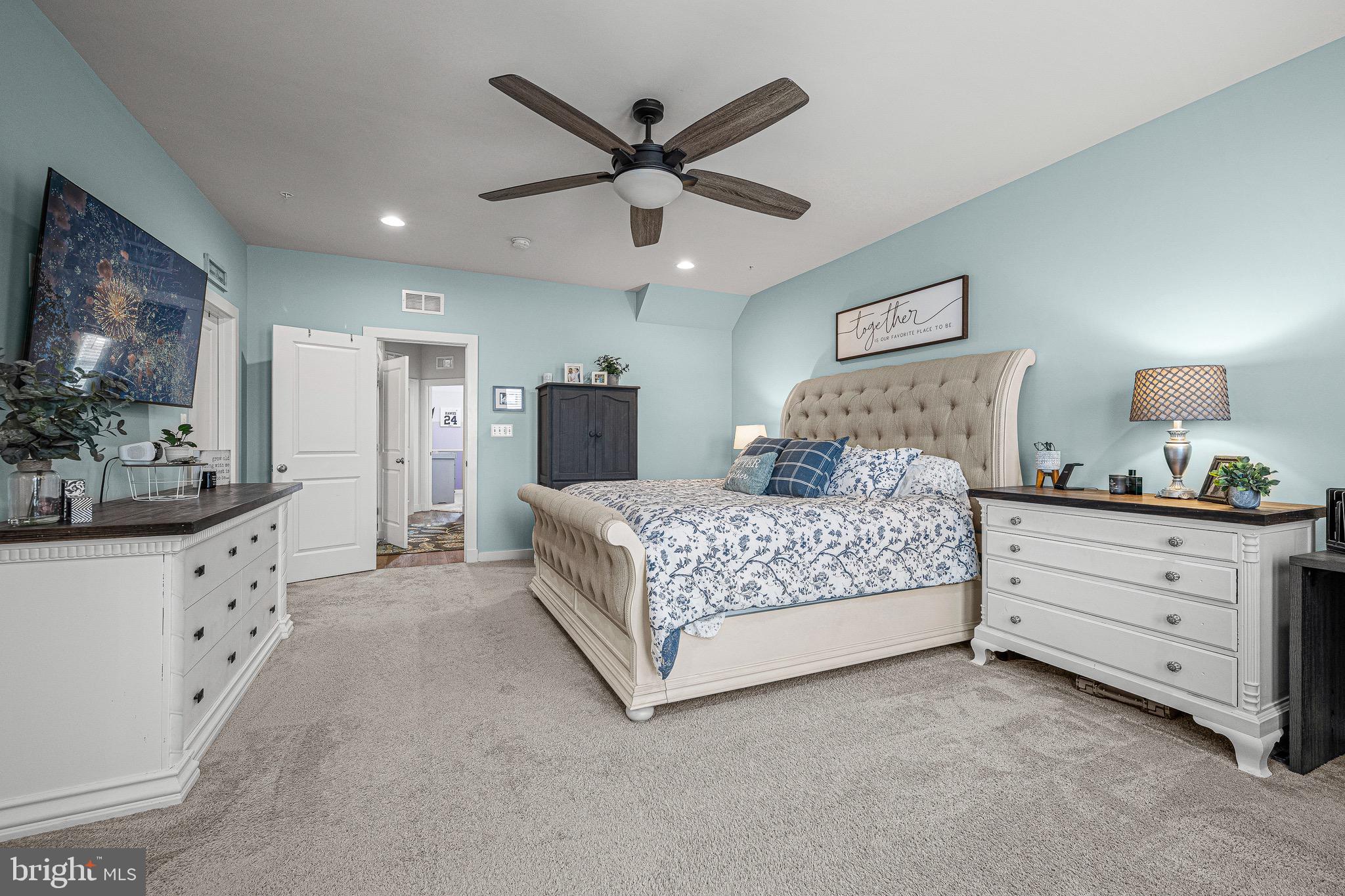 3451 Flatwoods Drive Frederick, MD 21704 - Photo 26 of 43 a bedroom with a large bed and a chandelier fan