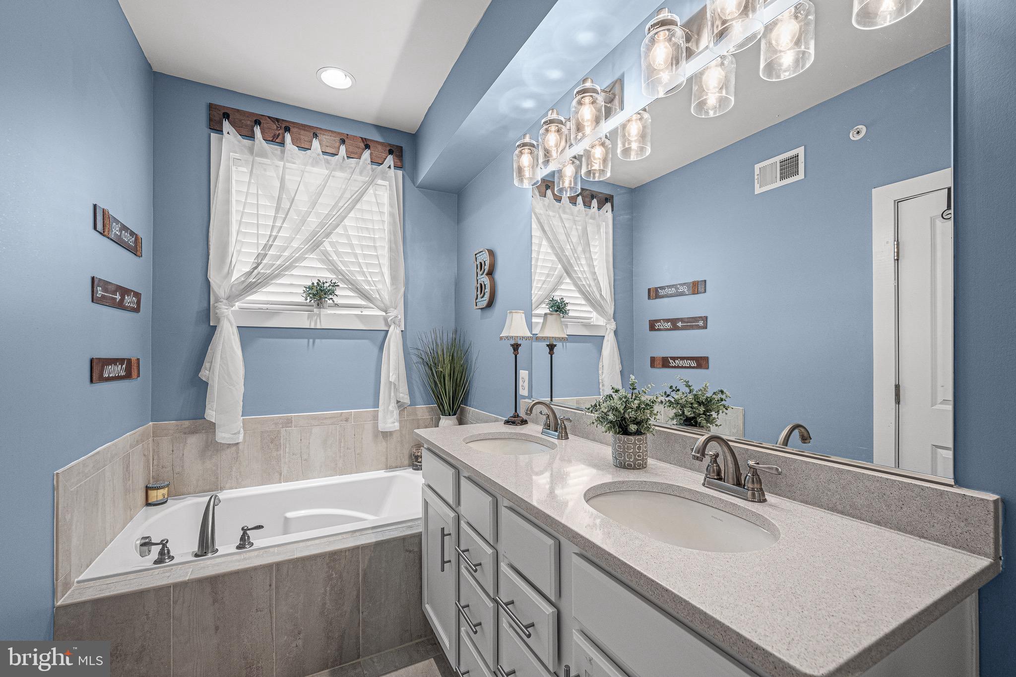 3451 Flatwoods Drive Frederick, MD 21704 - Photo 28 of 43 a bathroom with a tub sink and mirror