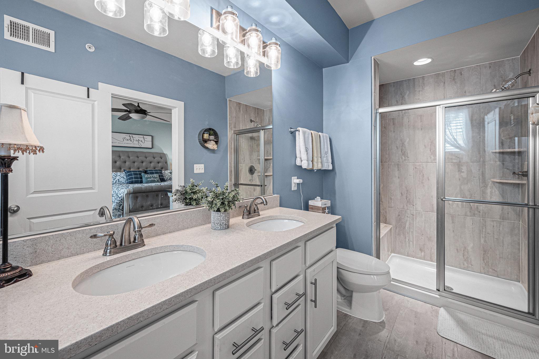 3451 Flatwoods Drive Frederick, MD 21704 - Photo 29 of 43 a bathroom with a double vanity sink toilet and shower