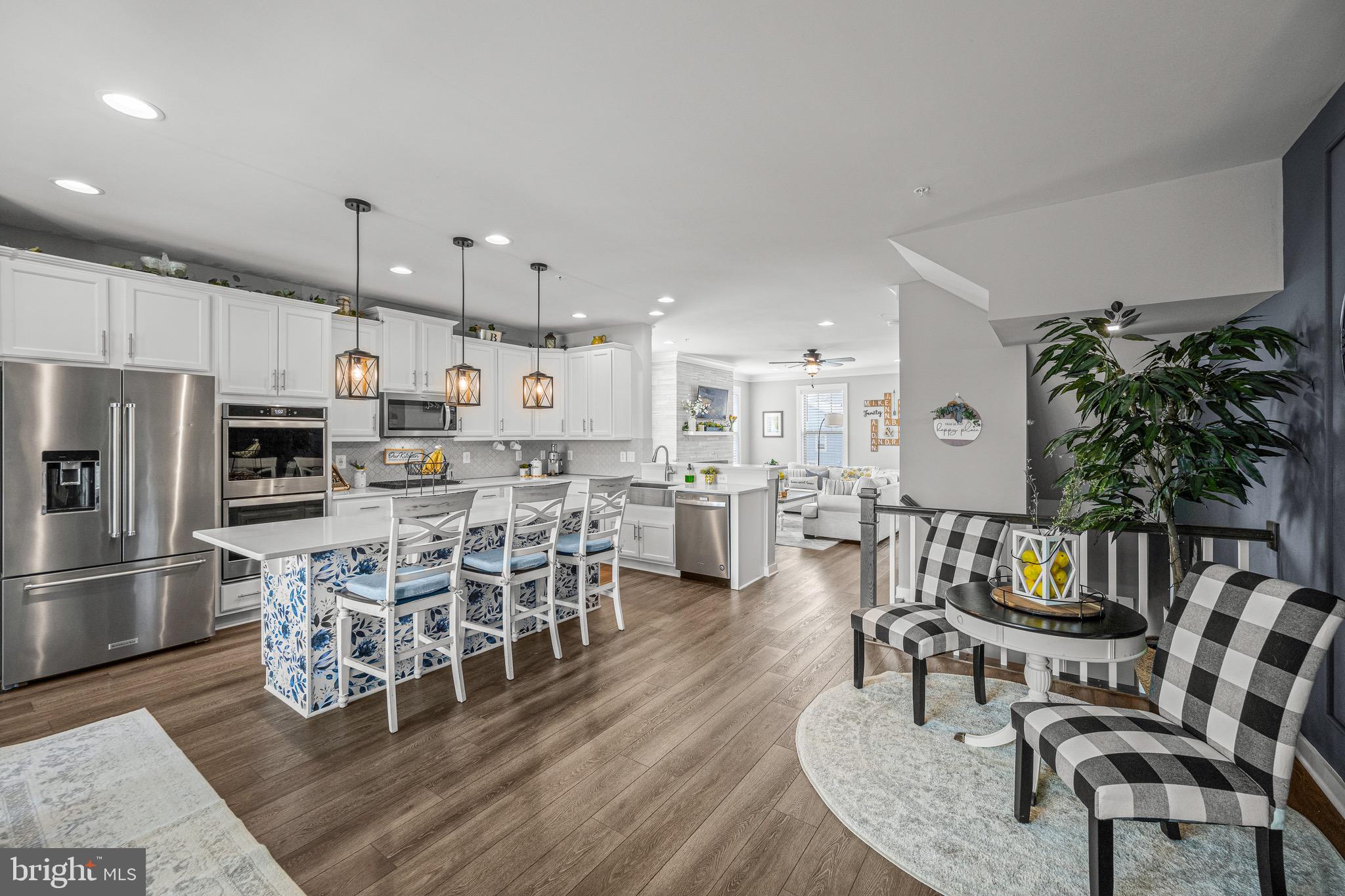 3451 Flatwoods Drive Frederick, MD 21704 - Photo 8 of 43 a kitchen with stainless steel appliances kitchen island granite countertop a table chairs and a refrigerator
