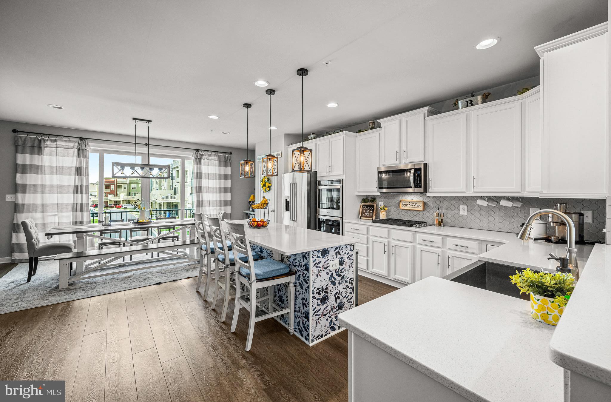 3451 Flatwoods Drive Frederick, MD 21704 - Photo 10 of 43 a kitchen with microwave a stove and white cabinets