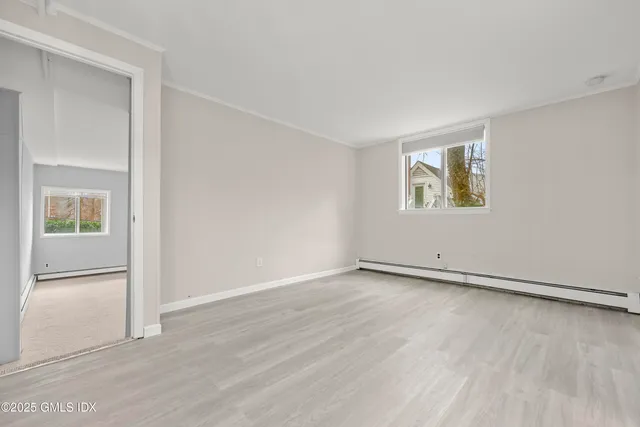 an empty room with windows and closet