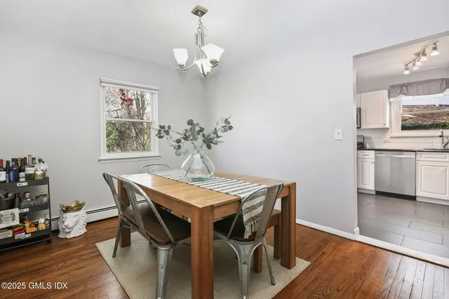 a view of a dining room with furniture and wooden floor