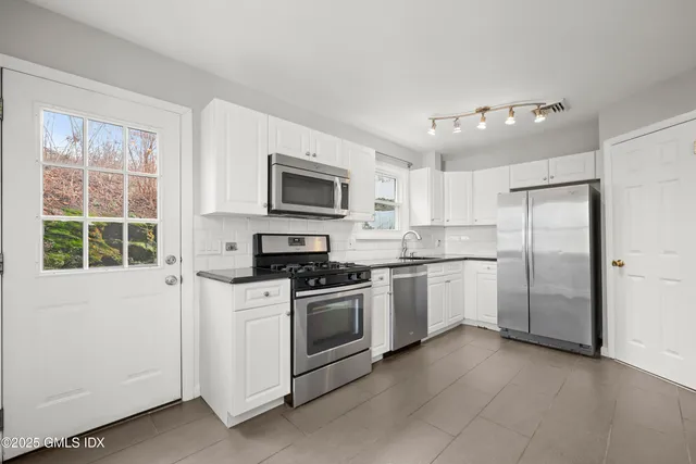 a kitchen with a refrigerator stove and microwave
