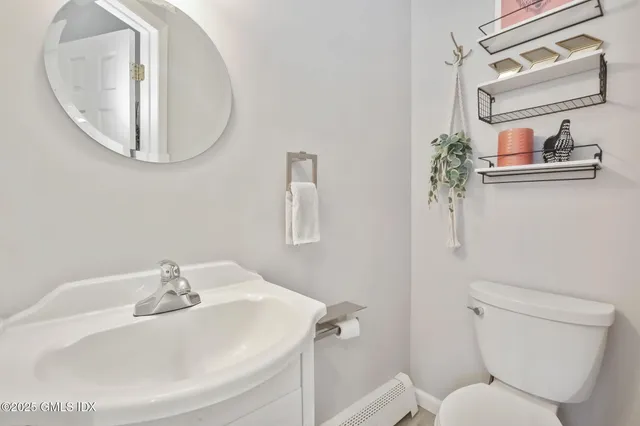 a bathroom with a sink mirror and toilet