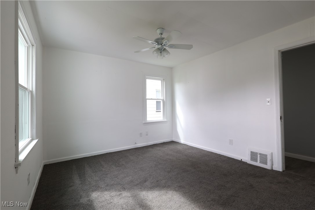 1332 South Green Road South Euclid, OH 44121 - Photo 9 of 23 Spare room featuring dark colored carpet and a ceiling fan