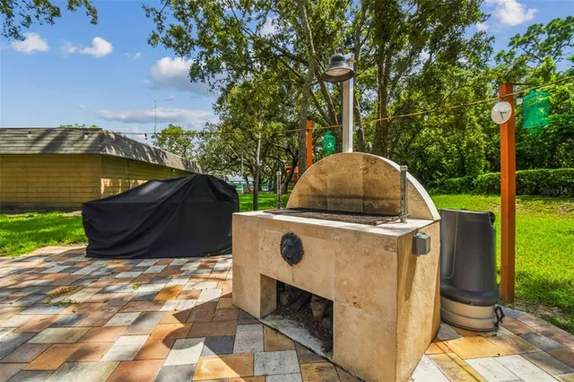 a view of backyard with swimming pool and outdoor seating
